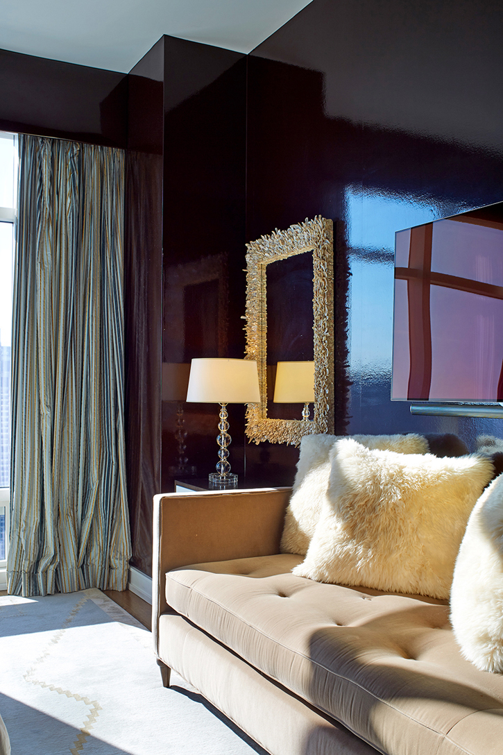 Play on elements with textures fur pillows, velvet daybed, shiny walls and shell mirror. 