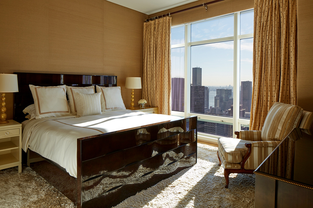 Master bedroom with upholstered silk walls for calming space in a busy city. 