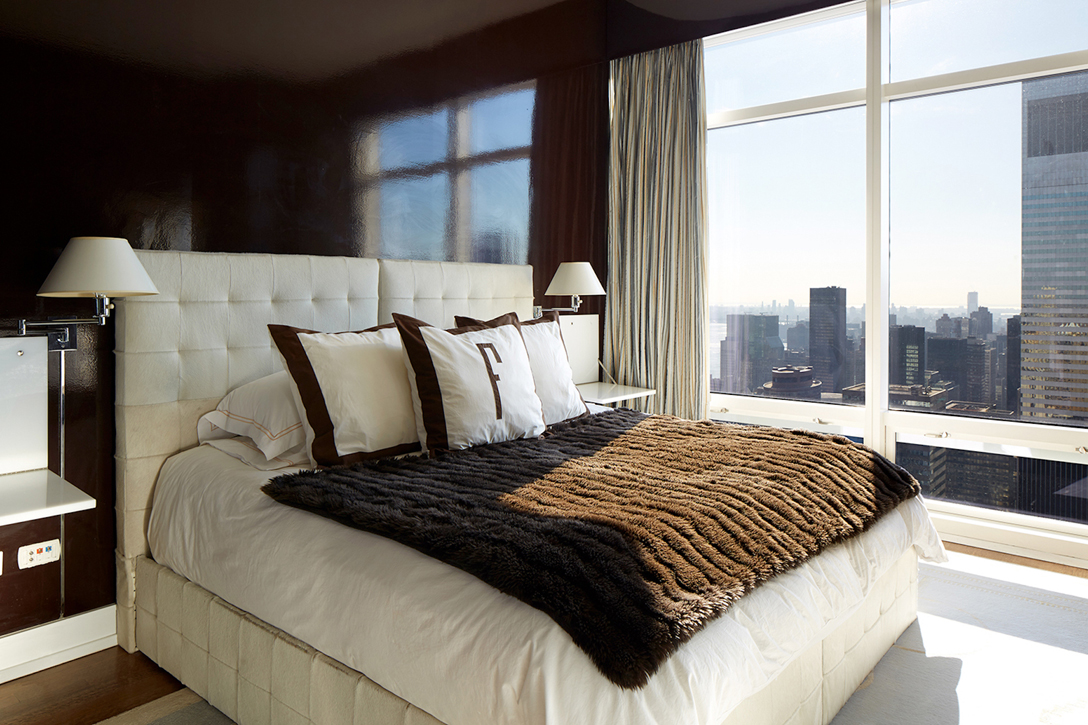 Patent leather chocolate walls add drama to cowhide covered headboards with trundle beds for teenage guests. 