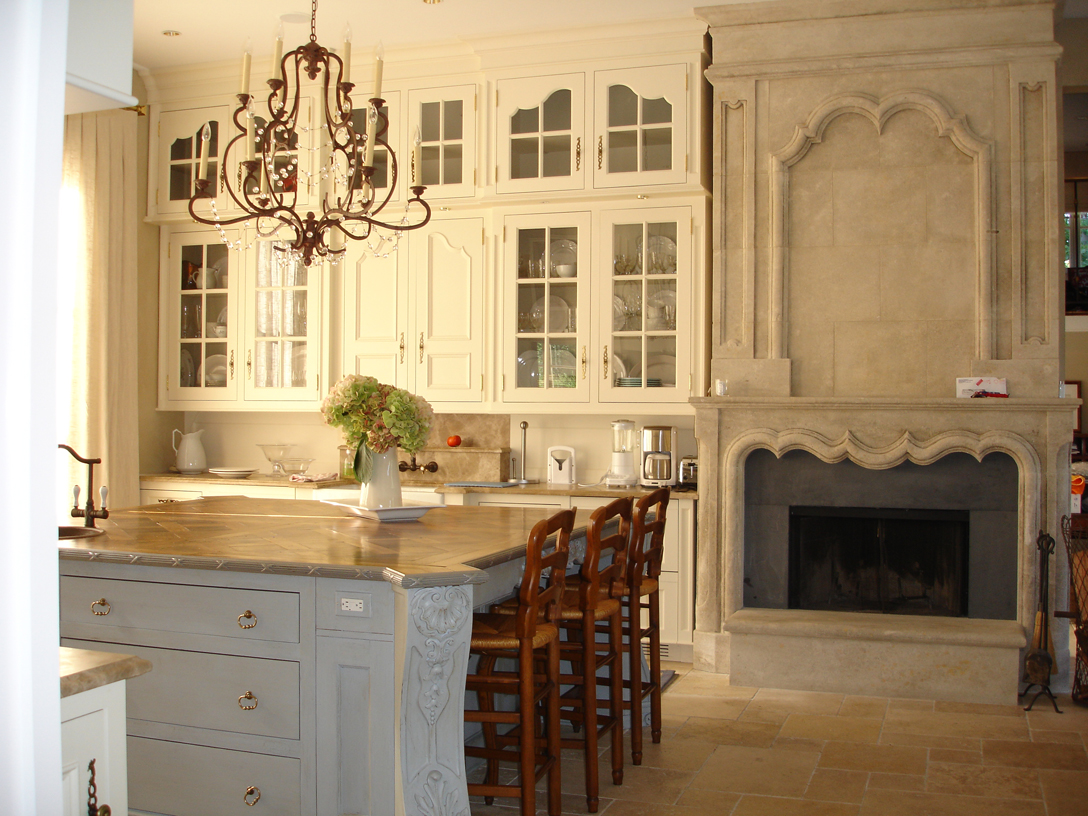 Limestone fireplace designed by Beverly Ellsley Design and fabricated in France. Island countertop is antique walnut parquet.  