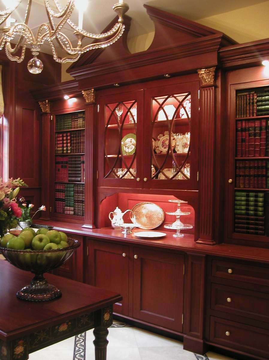 Doors to left and right of center section covered with faux books conceal food storage and small appliances. 