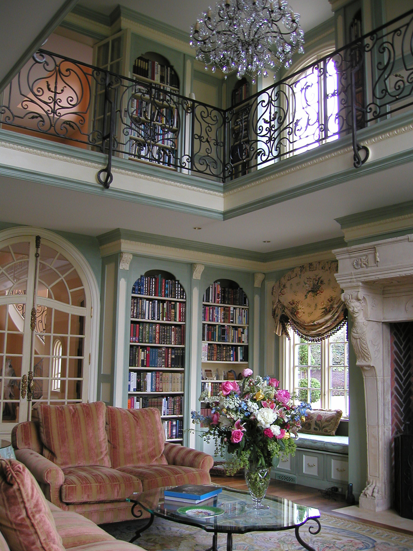Two story library with antique fireplace imported from France. All cabinetry designed and fabricated by Beverly Ellsley Design. 