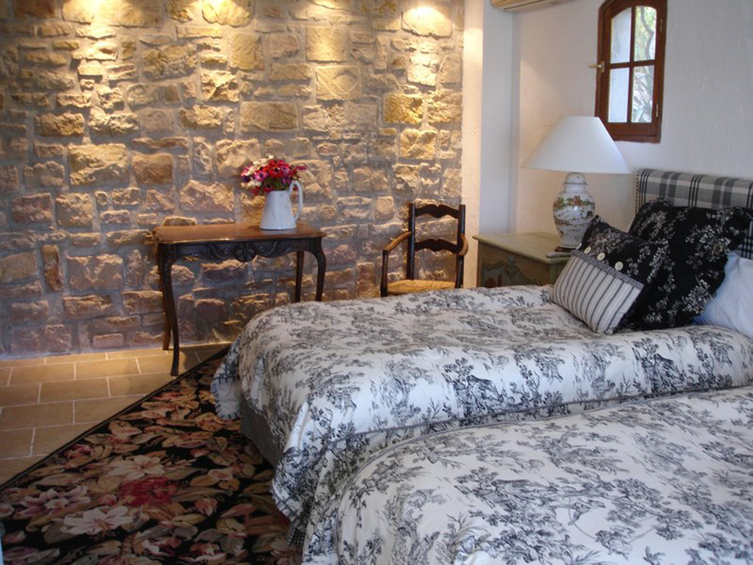 Renovated bedroom on first floor exposing original stonework.
